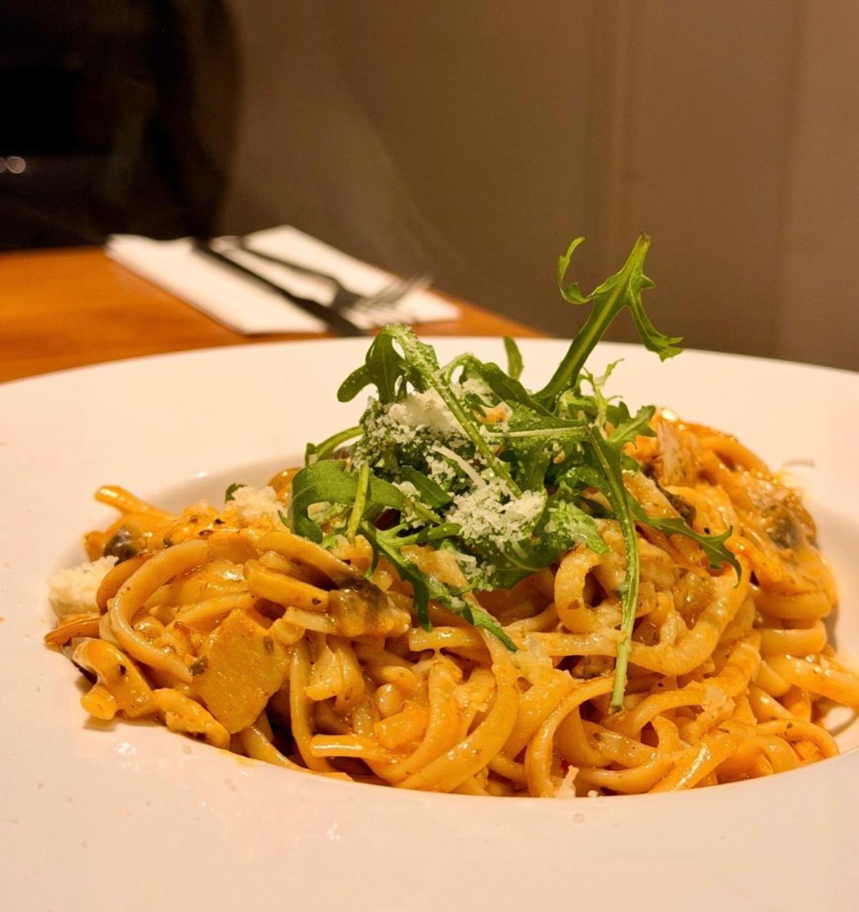 Fresh pasta with arugula and shaved parmesan